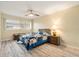 Comfortable bedroom with ceiling fan, a window, and wood-look laminate flooring at 11200 102Nd Ave # 16, Seminole, FL 33778