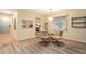 Cozy dining area featuring a glass table, pendant lighting, and views into the kitchen at 11200 102Nd Ave # 16, Seminole, FL 33778
