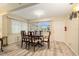 Inviting dining room with a wood table set, light walls and light wood laminate floors at 11200 102Nd Ave # 16, Seminole, FL 33778