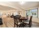 Open floor plan features living room and dining room with wood table set and laminate wood floors at 11200 102Nd Ave # 16, Seminole, FL 33778