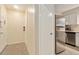 Hallway area features tile flooring, fire extinguisher and leads to the kitchen and a door at 11200 102Nd Ave # 16, Seminole, FL 33778