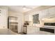 Bright kitchen with stainless steel appliances, white cabinets and counter tops, and laminate floors at 11200 102Nd Ave # 16, Seminole, FL 33778