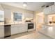 Efficient kitchen with stainless dishwasher and oven, white cabinets, and tile flooring at 11200 102Nd Ave # 16, Seminole, FL 33778