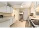 Charming kitchen featuring stainless steel fridge, white cabinetry, and light colored tile flooring at 11200 102Nd Ave # 16, Seminole, FL 33778