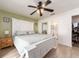 Spacious bedroom featuring a white bed frame, neutral bedding, and access to an en-suite bathroom at 12410 Cumberland Dr, Largo, FL 33773