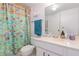 Bathroom featuring a vibrant, colorful shower curtain and ample counter space at 127 Tidewater Dr # 127, Bradenton, FL 34210