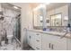 Elegant bathroom with dual sinks, granite countertop, and a glass-enclosed shower with marble-like tile at 127 Tidewater Dr # 127, Bradenton, FL 34210