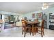 Dining area featuring a round table with seating for four, tile flooring, and an open view to living room at 127 Tidewater Dr # 127, Bradenton, FL 34210