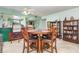 Warm dining room with a round table, stylish chairs, and views into the living and kitchen areas at 127 Tidewater Dr # 127, Bradenton, FL 34210