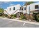 Condo complex with white stucco, wood trim, stairway access, landscaped gardens, and well-maintained grounds at 127 Tidewater Dr # 127, Bradenton, FL 34210