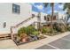 Well-maintained condo complex with white stucco, wood accents, lush landscaping, and convenient parking at 127 Tidewater Dr # 127, Bradenton, FL 34210