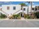 Bright condo complex featuring white stucco, wood trim, colorful landscaping, and convenient parking at 127 Tidewater Dr # 127, Bradenton, FL 34210