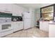 Bright kitchen featuring white appliances, ample counter space, and convenient storage at 127 Tidewater Dr # 127, Bradenton, FL 34210