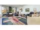 Inviting living room with neutral walls, comfortable seating, stylish rug, and views of lush greenery at 127 Tidewater Dr # 127, Bradenton, FL 34210