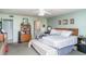 A cozy bedroom with a comfortable king-size bed, ceiling fan, and a view of the adjacent bathroom at 127 Tidewater Dr # 127, Bradenton, FL 34210