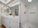 Bathroom with a double sink vanity on the left and a stand up shower with glass door on the right at 128 Nancy Dr # 128, Oldsmar, FL 34677