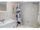 Full bathroom with vanity, tiled shower, and cat-themed curtain rod at 128 Nancy Dr # 128, Oldsmar, FL 34677
