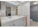Bathroom featuring a double sink vanity, large mirror, and access to walk-in closet at 128 Nancy Dr # 128, Oldsmar, FL 34677