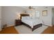 Comfortable bedroom with a queen-size bed, wood floors, and a ceiling fan at 128 Nancy Dr # 128, Oldsmar, FL 34677