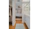 A view from the bathroom to the bedroom with a ceiling fan and light colored walls at 128 Nancy Dr # 128, Oldsmar, FL 34677