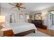 Spacious bedroom with wood floors, a ceiling fan, and ample natural light at 128 Nancy Dr # 128, Oldsmar, FL 34677