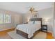 Bedroom featuring a queen-size bed, ceiling fan, and window at 128 Nancy Dr # 128, Oldsmar, FL 34677