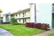 Inviting two-story condo with lush green lawn and colorful landscaping at 128 Nancy Dr # 128, Oldsmar, FL 34677