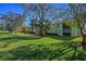 Well-maintained condo building surrounded by lush greenery and mature trees on a sunny day at 128 Nancy Dr # 128, Oldsmar, FL 34677