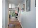 Bright hallway with wood floors leads to an open living area at 128 Nancy Dr # 128, Oldsmar, FL 34677