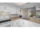 Well-lit kitchen area featuring granite countertops and white cabinetry at 128 Nancy Dr # 128, Oldsmar, FL 34677