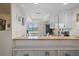 Open kitchen with granite counters, white cabinets, and stainless-steel appliances at 128 Nancy Dr # 128, Oldsmar, FL 34677