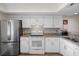 Well-equipped kitchen with stainless steel appliances, white cabinets, and granite countertops at 128 Nancy Dr # 128, Oldsmar, FL 34677
