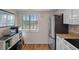Efficient kitchen area with stainless steel refrigerator, built-in microwave, and modern appliances at 128 Nancy Dr # 128, Oldsmar, FL 34677
