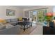Comfortable living area features neutral tones, a large sectional, and screened patio access at 128 Nancy Dr # 128, Oldsmar, FL 34677