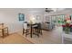 Open-concept living area with dining table, comfortable seating, and outdoor access at 128 Nancy Dr # 128, Oldsmar, FL 34677