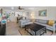 Bright living room featuring a large sectional sofa, ceiling fan, and an open-concept kitchen at 128 Nancy Dr # 128, Oldsmar, FL 34677