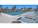 Community pool with clear blue water and plenty of lounge chairs for relaxing in the sun at 128 Nancy Dr # 128, Oldsmar, FL 34677