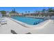 Relaxing community pool featuring lounge chairs and a clear blue sky on a sunny day at 128 Nancy Dr # 128, Oldsmar, FL 34677