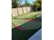 A fun outdoor putting green surrounded by a tall privacy fence offers recreation at home at 128 Nancy Dr # 128, Oldsmar, FL 34677