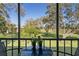 Serene screened-in patio with a view of the lush green landscape beyond at 128 Nancy Dr # 128, Oldsmar, FL 34677