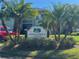 Condominium Association II sign is set among lush landscaping and mature palm trees at 128 Nancy Dr # 128, Oldsmar, FL 34677