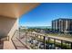Spacious balcony with beautiful views of the ocean, beach, a neighboring building, and convenient parking at 1480 Gulf Blvd # 410, Clearwater Beach, FL 33767