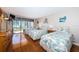 Bright bedroom featuring three beds and a sliding glass door to balcony at 1480 Gulf Blvd # 410, Clearwater Beach, FL 33767