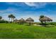 Community grounds featuring thatched umbrellas providing shade on a sunny day near the ocean at 1480 Gulf Blvd # 410, Clearwater Beach, FL 33767