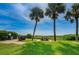 Picnic area with picnic table, grill, and trash bins, located on the lawn near the beach at 1480 Gulf Blvd # 410, Clearwater Beach, FL 33767