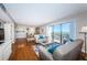 Bright and airy living room and dining area featuring sliding glass doors to a scenic balcony with stunning views at 1480 Gulf Blvd # 410, Clearwater Beach, FL 33767