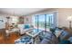Cozy living room featuring a dining area, sliding glass doors to a balcony, and comfortable seating with bright decor at 1480 Gulf Blvd # 410, Clearwater Beach, FL 33767