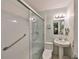 Bathroom featuring a shower with glass door, toilet, and pedestal sink with mirror at 1520 S Richard Ave, Tampa, FL 33629