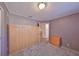 Cozy bedroom with neutral gray walls, built-in cabinet/Murphy bed, and plush gray carpeting at 1520 S Richard Ave, Tampa, FL 33629