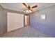 Bedroom featuring gray walls, ceiling fan, closet, and plush gray carpeting at 1520 S Richard Ave, Tampa, FL 33629